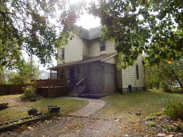 1302 Duncan Street Southwest Massillon, OH 44647 - Photo 1 of 22 Rear view of house featuring a lawn