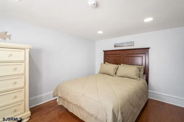 a bedroom with a bed and a dresser