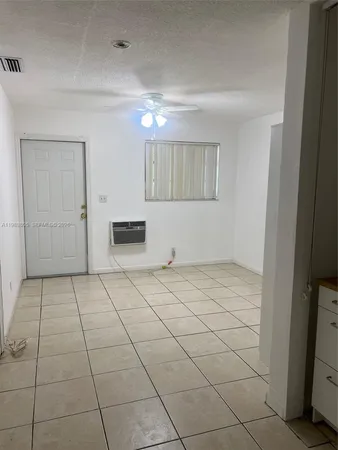 a view of a livingroom with an empty space and a window