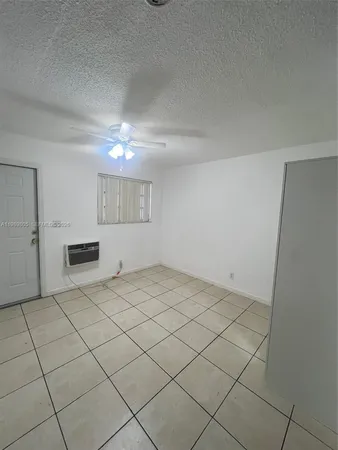 a view of a livingroom with an empty space and a window