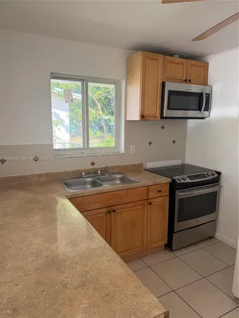 a kitchen with stainless steel appliances granite countertop a sink and a stove top oven with granite countertops