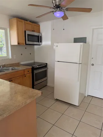 a kitchen with a sink appliances and cabinets