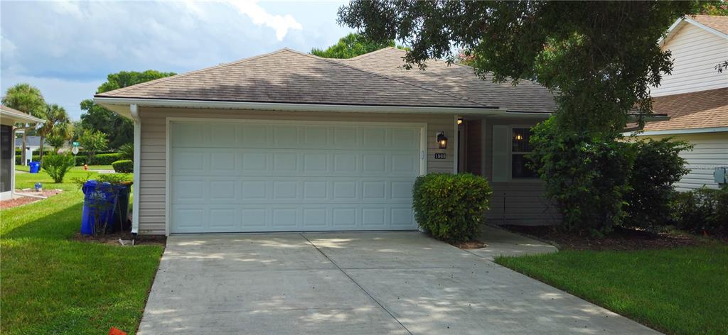 1568 Grove Court Tavares, FL 32778 - Photo 2 of 15 a front view of a house with garden