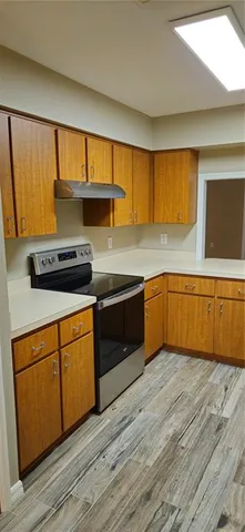 a kitchen with a sink a window and cabinets