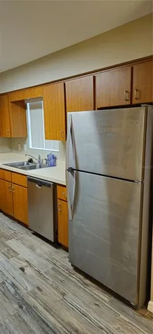 a view of a kitchen with wooden floor and a sink
