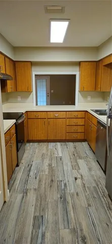 a kitchen with stainless steel appliances granite countertop a stove a sink and a refrigerator