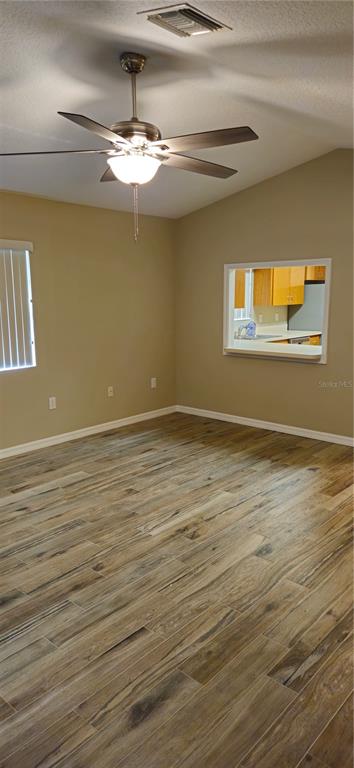 1568 Grove Court Tavares, FL 32778 - Photo 8 of 15 a view of a room with wooden floor and chandelier
