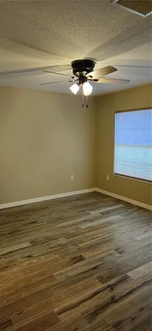 a view of a room with wooden floor and cabinet