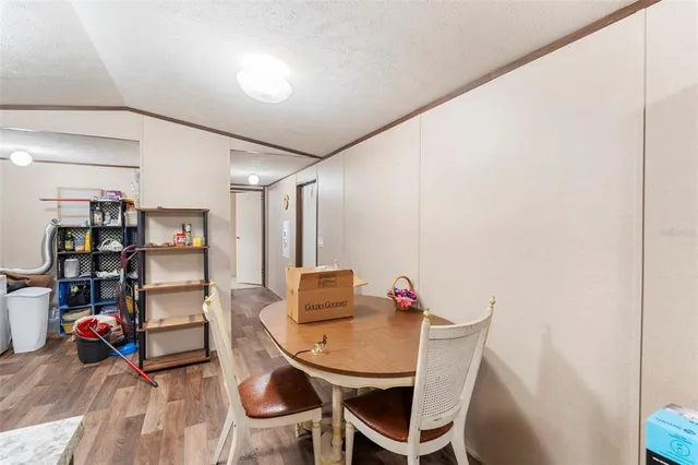 an aerial view of house with yard and mountain view in back