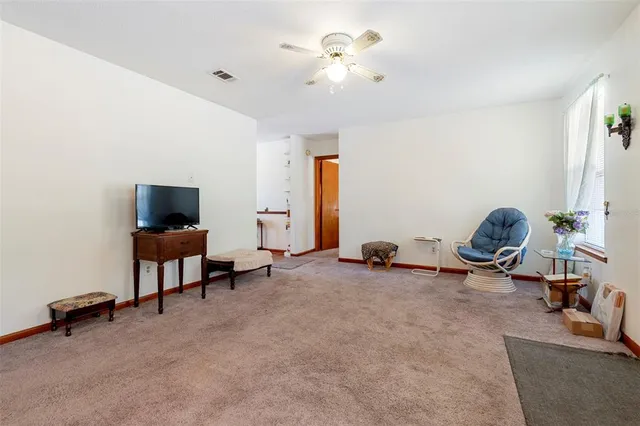 a kitchen with granite countertop a stove a sink and a refrigerator