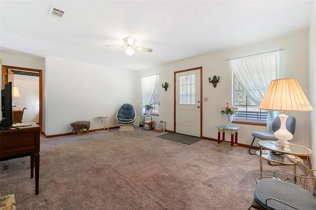 a kitchen with sink a refrigerator and wooden floor