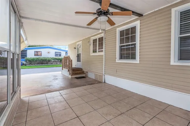 a view of a porch with furniture and a yard