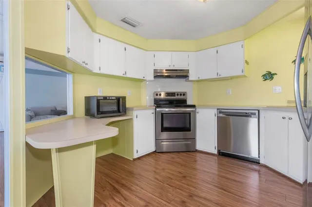 a kitchen with a sink a stove and cabinets