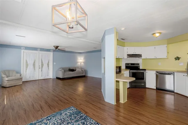 a view of kitchen with sink and wooden floor