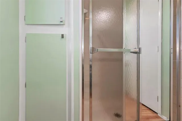 a bathroom with a glass shower door