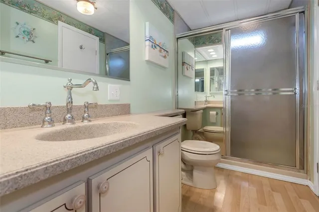 a bathroom with a sink toilet and a mirror