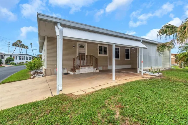 a view of a house with backyard porch and sitting area