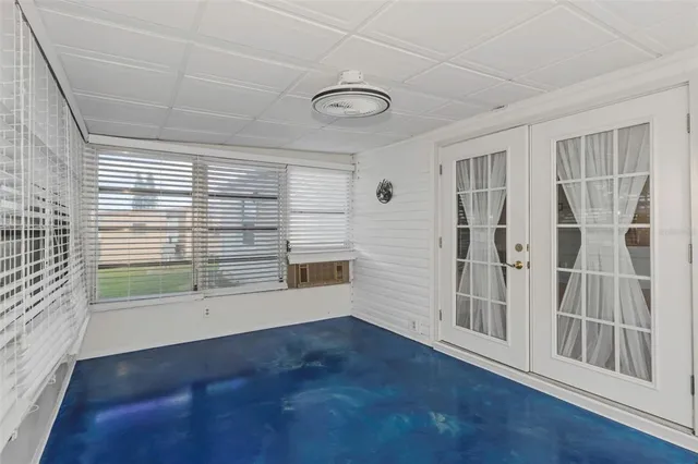 en empty room with wooden floor and windows