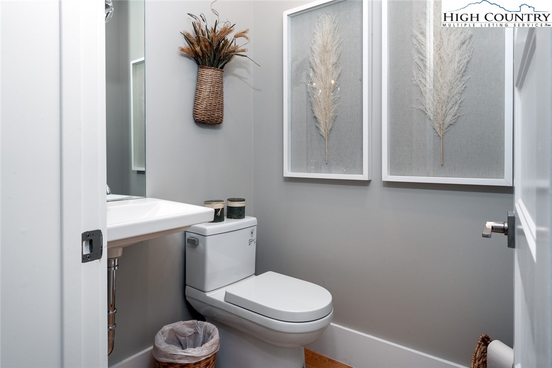1180 Pinnacle Drive Boone, NC 28607 - Photo 22 of 50 a bathroom with a toilet sink and mirror