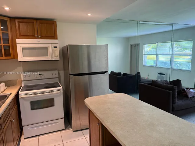 a kitchen with a refrigerator stove and microwave