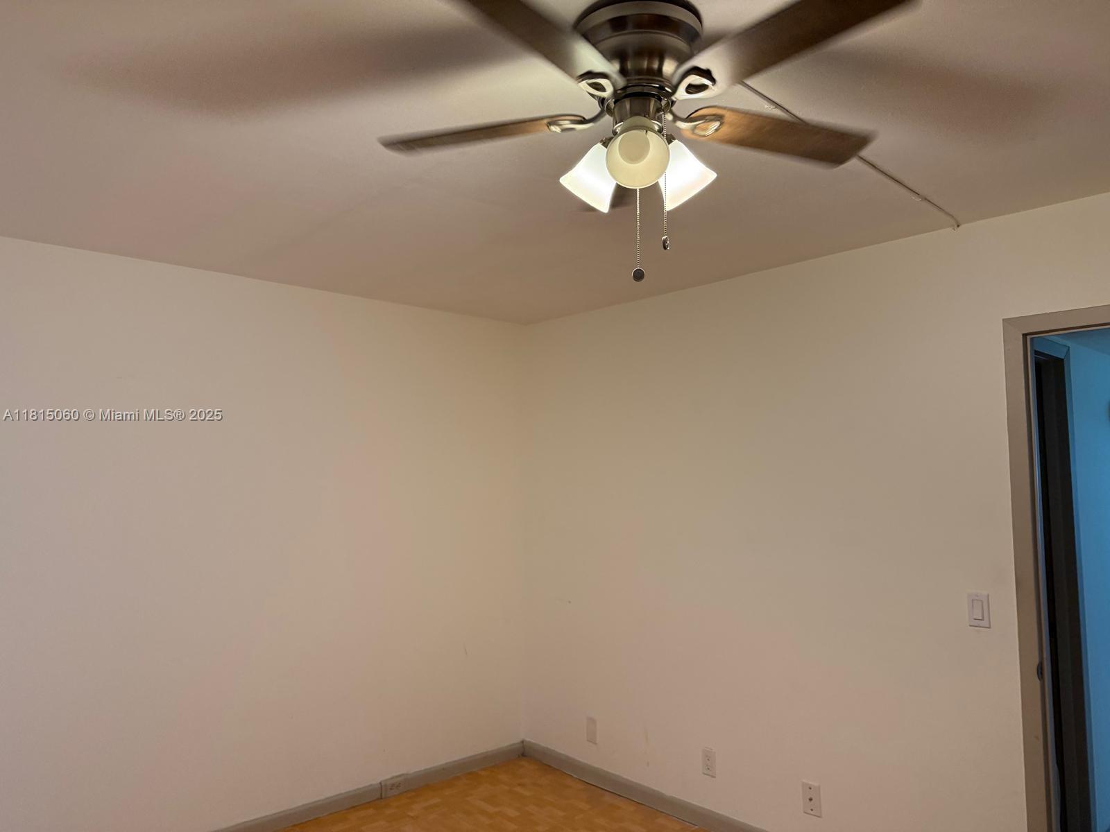 217 Suffolk F, Unit 217 Boca Raton, FL 33434 - Photo 5 of 11 a view of a chandelier fan and a window