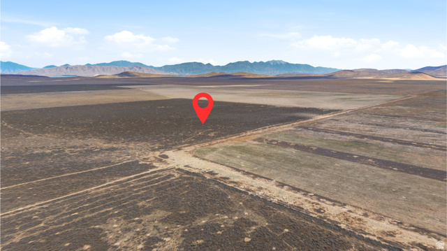 18150 West County Road, Unit 14 Cedar Valley, UT 84013 - Photo 1 of 4 Expansive undeveloped land featuring natural desert vegetation, a level topography, and a distant mountain range backdrop