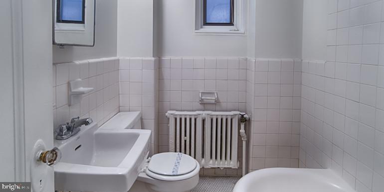 3900 Chestnut Street, Unit 515 Philadelphia, PA 19104 - Photo 6 of 13 a white toilet sitting next to a bathroom sink