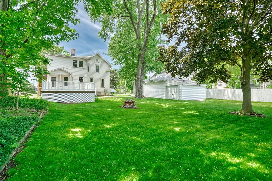27 Martin Street Webster, NY 14580 - Photo 4 of 48 BACKYARD VIEW OF REAR . . DECK, FIREPIT, GARAGE