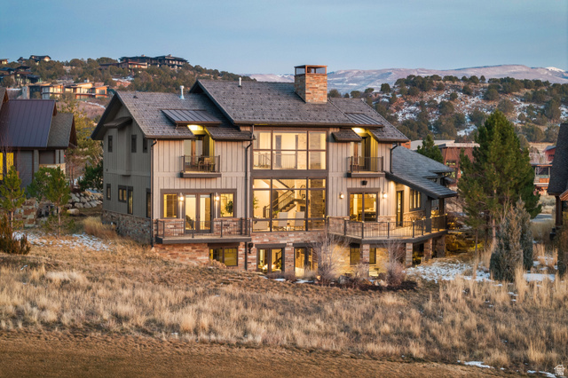 707 Chimney Rock Road, Unit 247 Heber City, UT 84032 - Photo 2 of 64 Back of house with a balcony, a chimney, board and batten siding, and stone siding