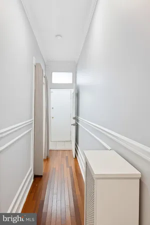 a view of a hallway with wooden floor