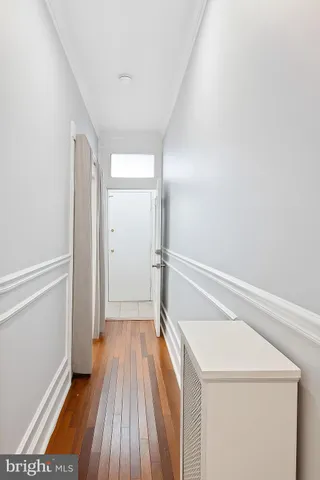 a view of a hallway with wooden floor