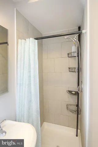 a bathroom with a shower and a tub
