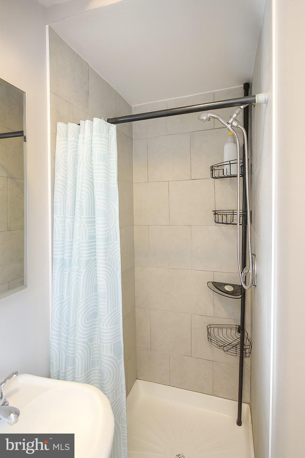 2425 West North Avenue Baltimore, MD 21216 - Photo 6 of 7 a bathroom with a shower and a tub
