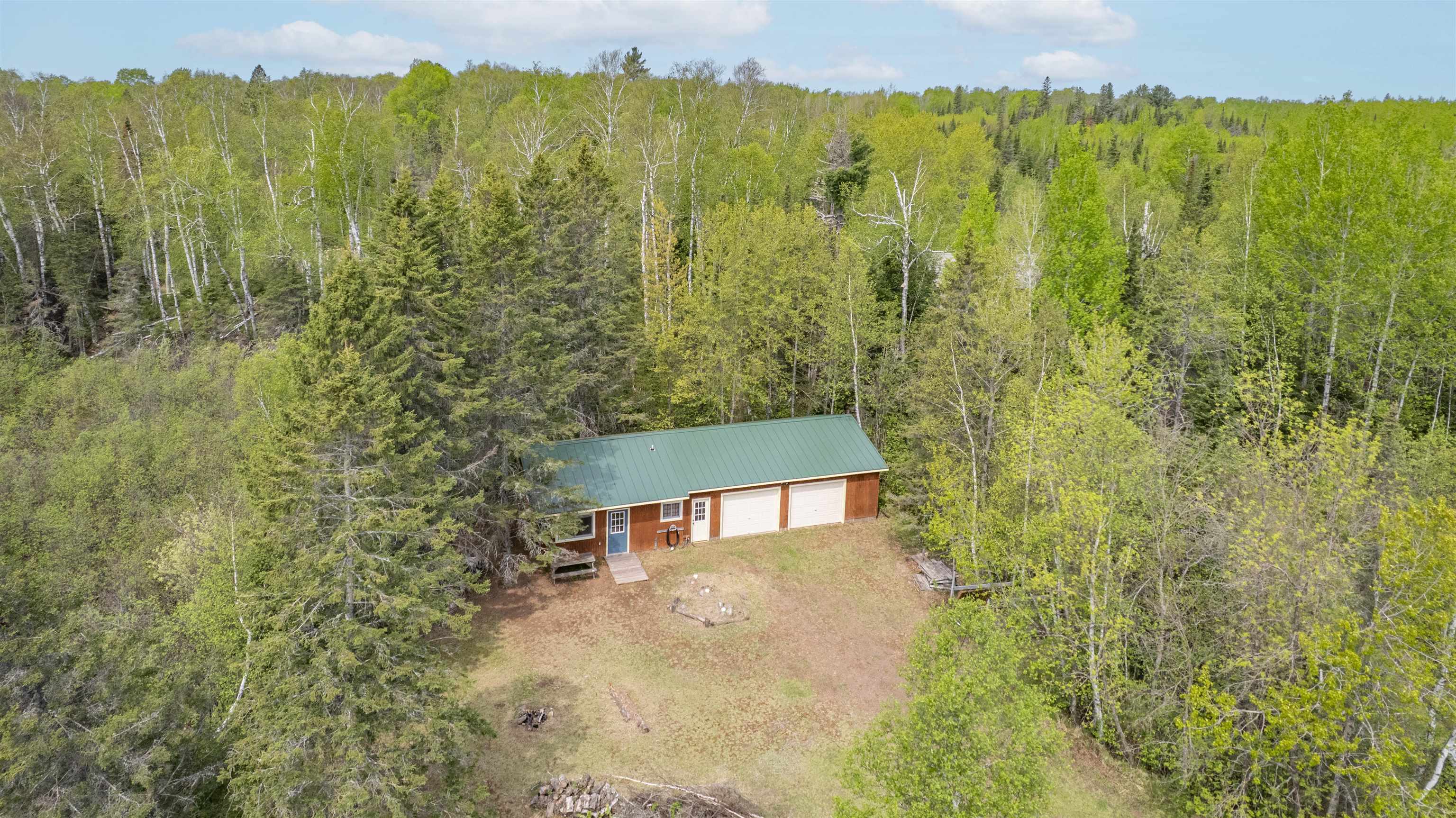 9320 West Branch Road Duluth, MN 55803 - Photo 41 of 41 Aerial view of property and surrounding area with a forest