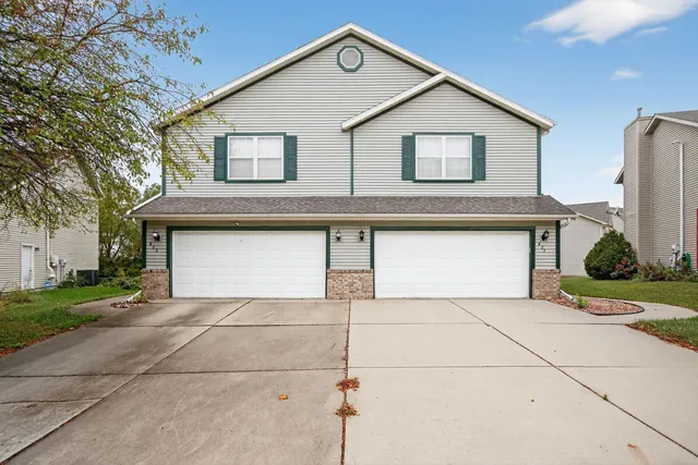 a front view of a house with garage