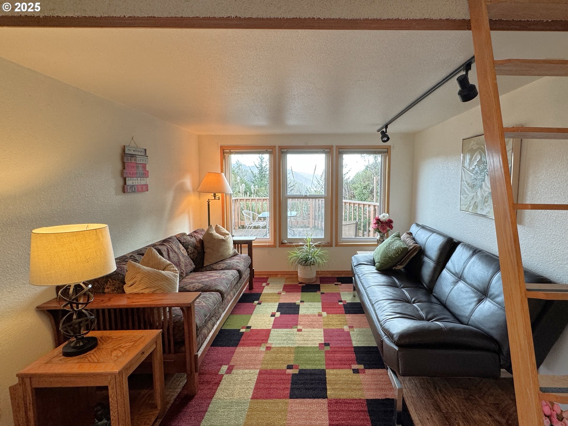 19921 Whaleshead Road, Unit OV13 Brookings, OR 97415 - Photo 11 of 43 a living room with furniture and a lamp