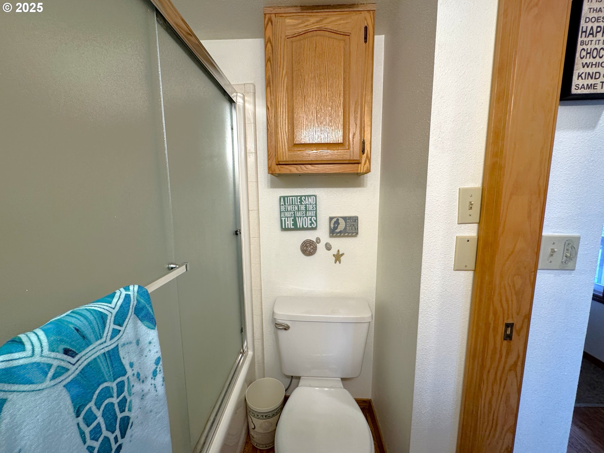 19921 Whaleshead Road, Unit OV13 Brookings, OR 97415 - Photo 25 of 43 a white toilet sitting next to a bathroom sink