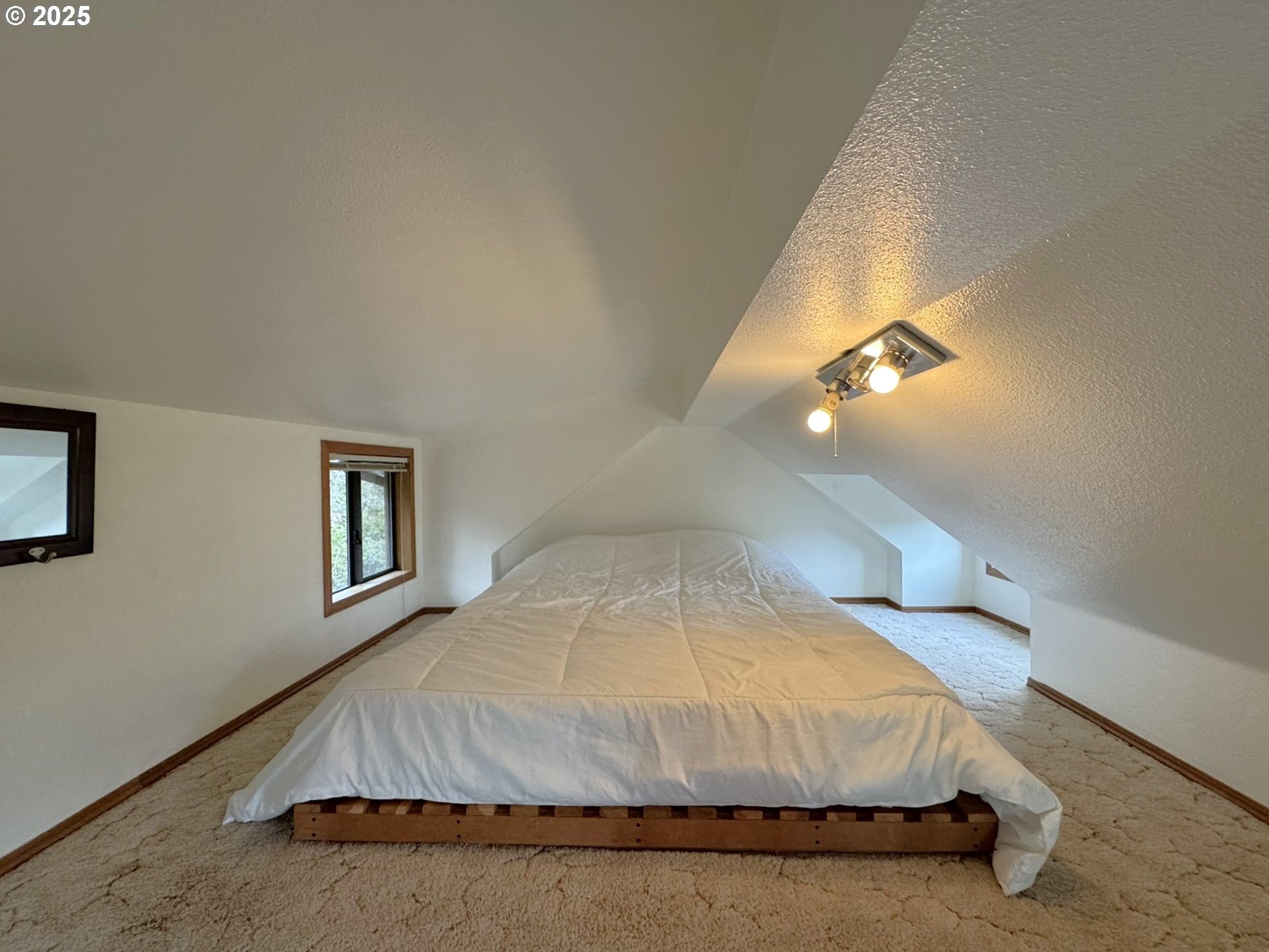 19921 Whaleshead Road, Unit OV13 Brookings, OR 97415 - Photo 29 of 43 a bedroom with a bed and a night stand