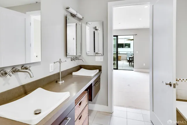 a bathroom with a sink tub vanity and a mirror
