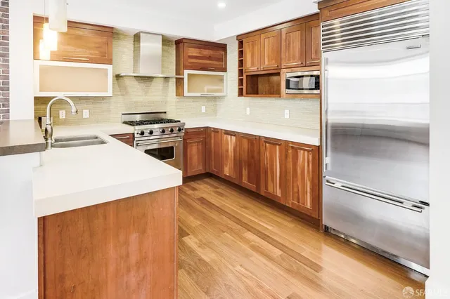 a kitchen with stainless steel appliances a stove and a refrigerator