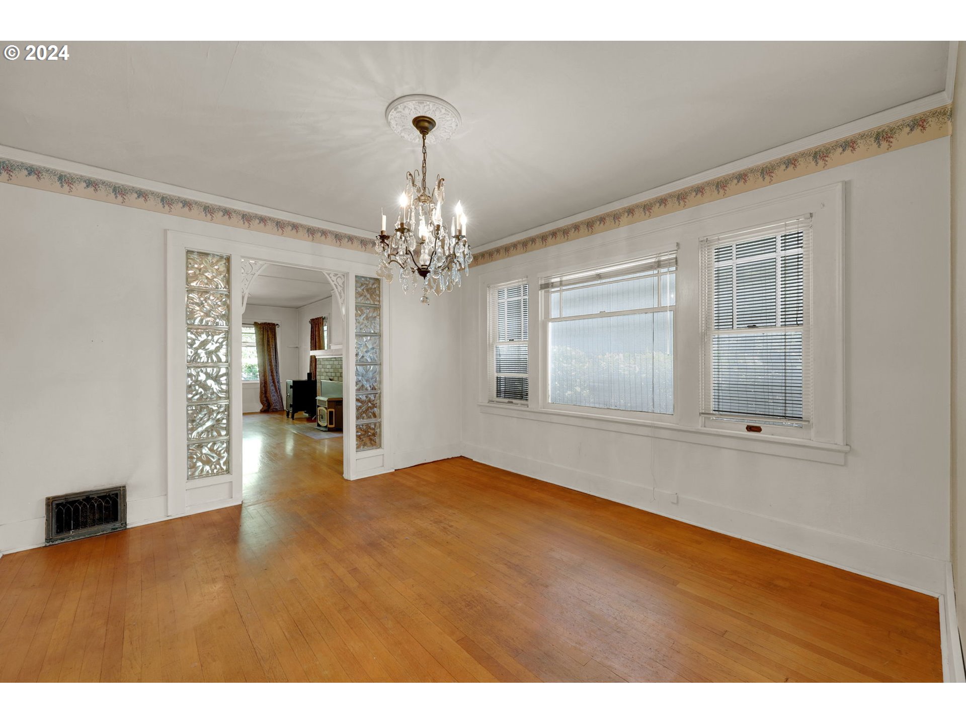 110 Elkay Drive Eugene, OR 97404 - Photo 14 of 29 a view of an empty room with wooden floor and kitchen view