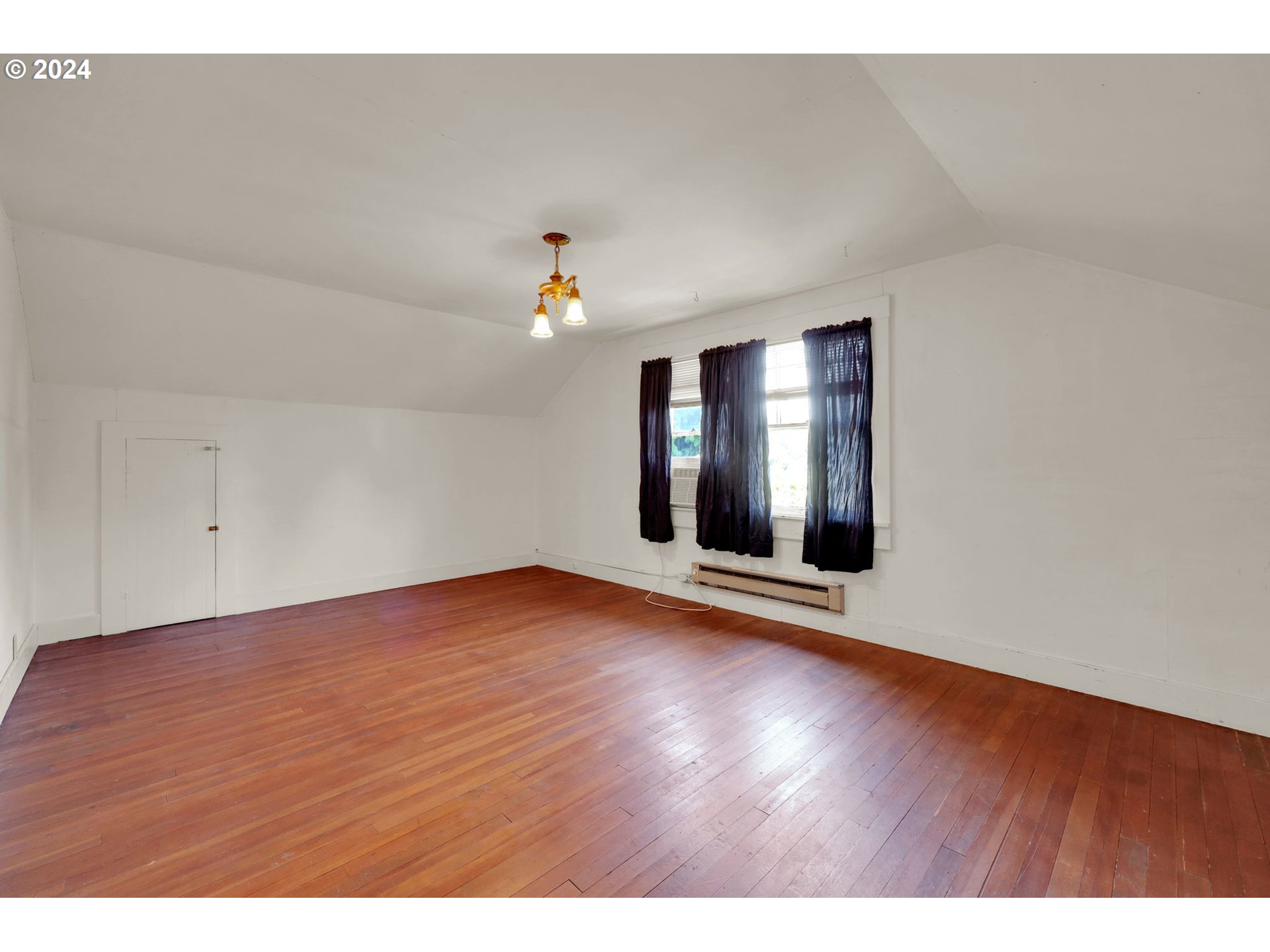 110 Elkay Drive Eugene, OR 97404 - Photo 17 of 29 a view of an empty room with window and wooden floor