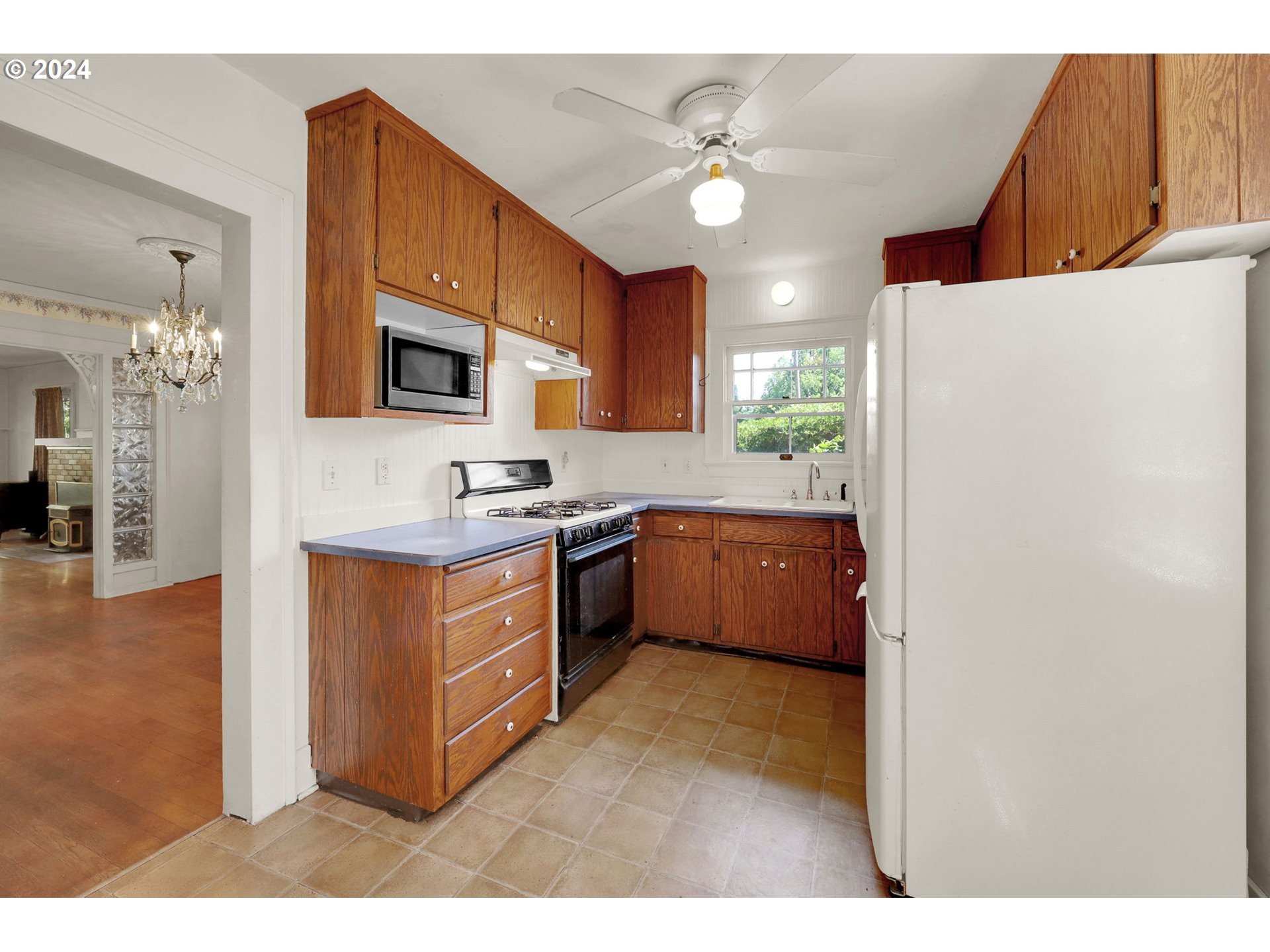 110 Elkay Drive Eugene, OR 97404 - Photo 6 of 29 a kitchen with kitchen island granite countertop a sink appliances cabinets and a counter top space