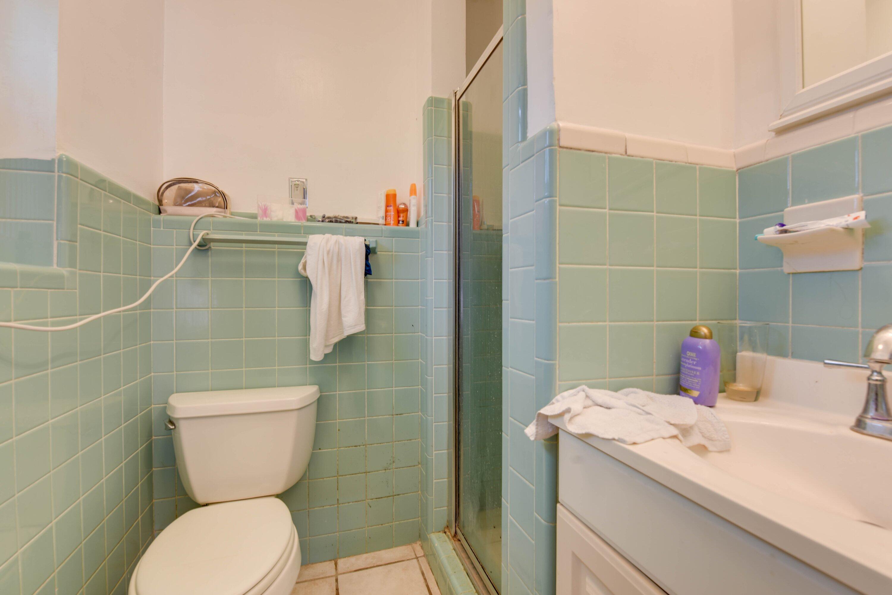 3421 Riviera Drive Key West, FL 33040 - Photo 15 of 32 a bathroom with a toilet sink and mirror