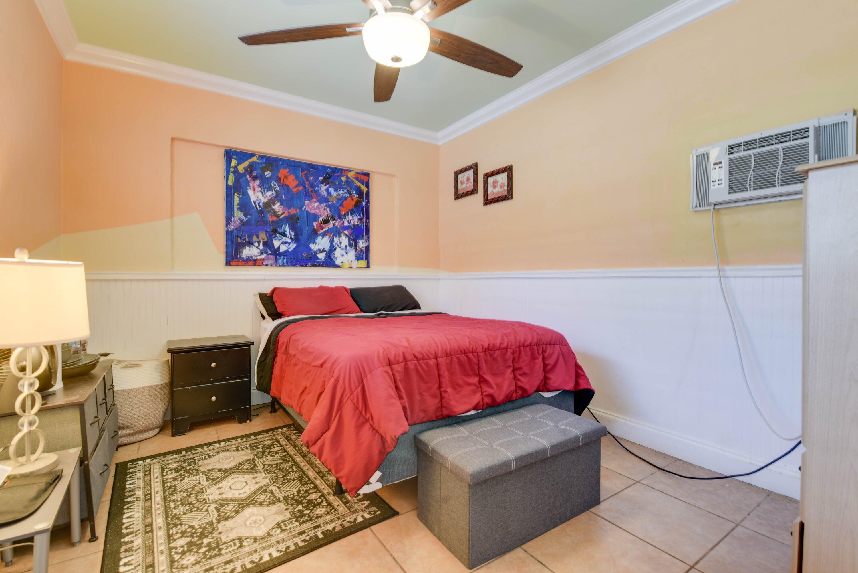 3421 Riviera Drive Key West, FL 33040 - Photo 16 of 32 a bed room with a bed and a painting on the wall
