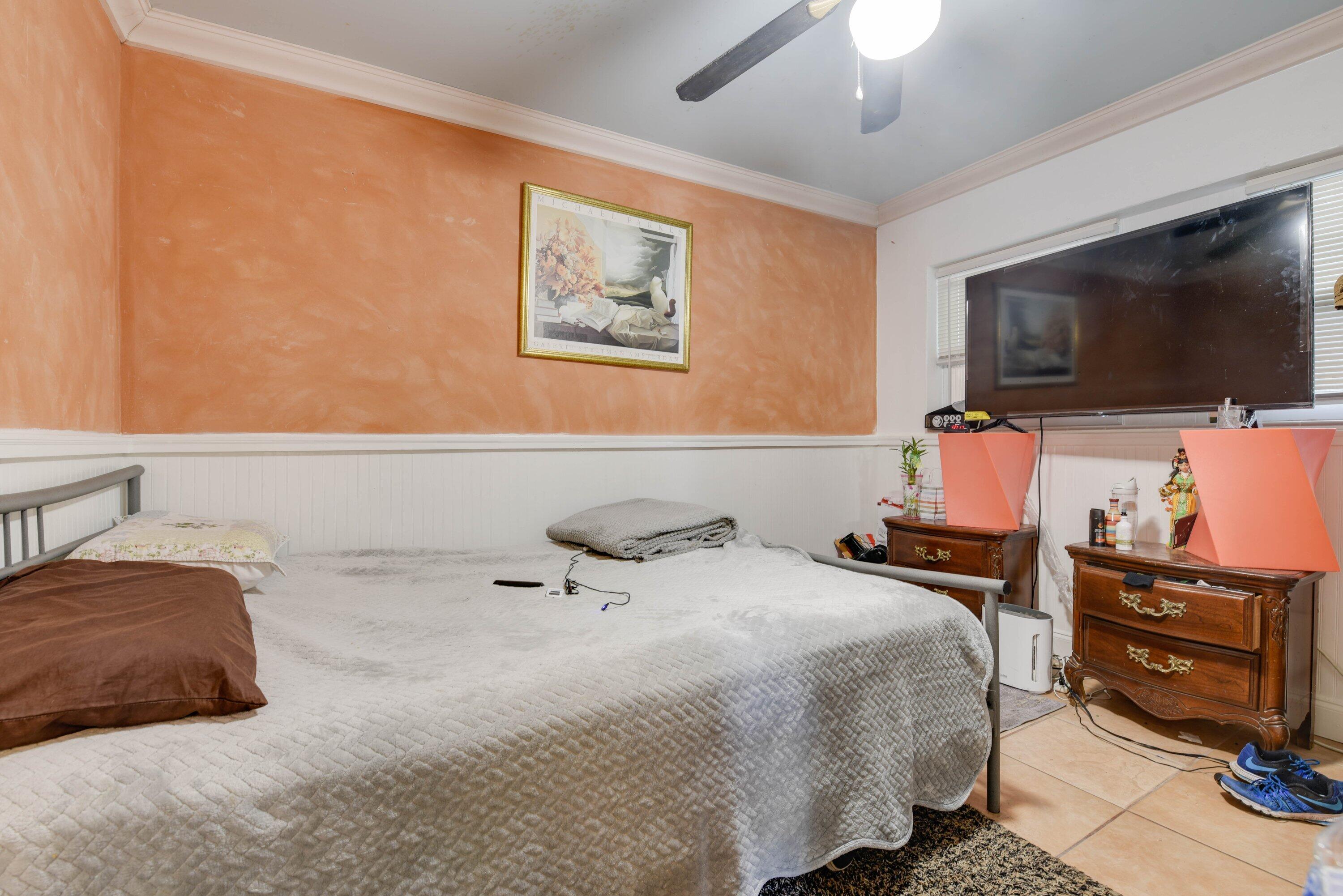 3421 Riviera Drive Key West, FL 33040 - Photo 19 of 32 a bedroom with a bed and flat screen tv