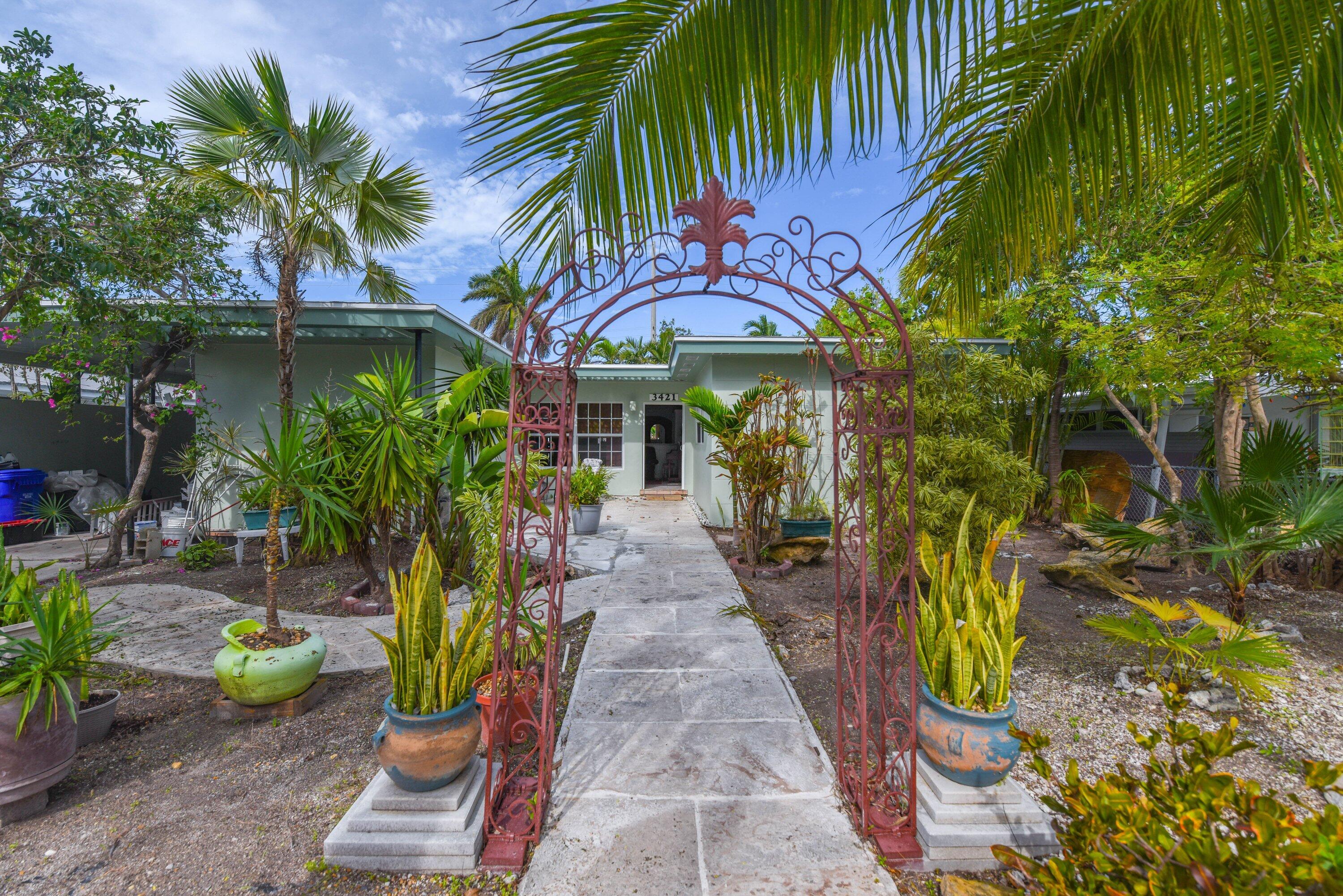 3421 Riviera Drive Key West, FL 33040 - Photo 2 of 32 a view of a backyard with potted plants