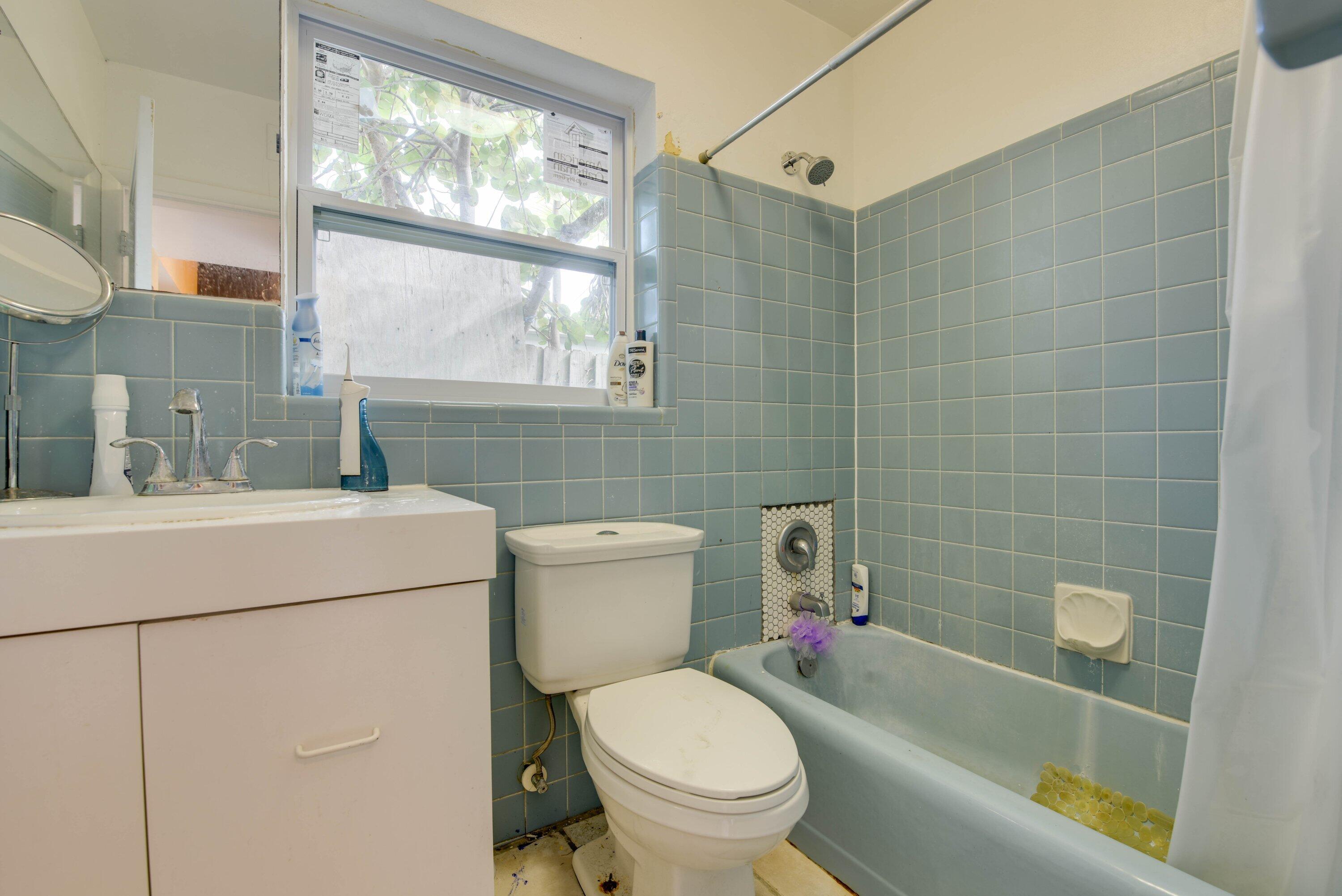 3421 Riviera Drive Key West, FL 33040 - Photo 21 of 32 a bathroom with a toilet sink and mirror
