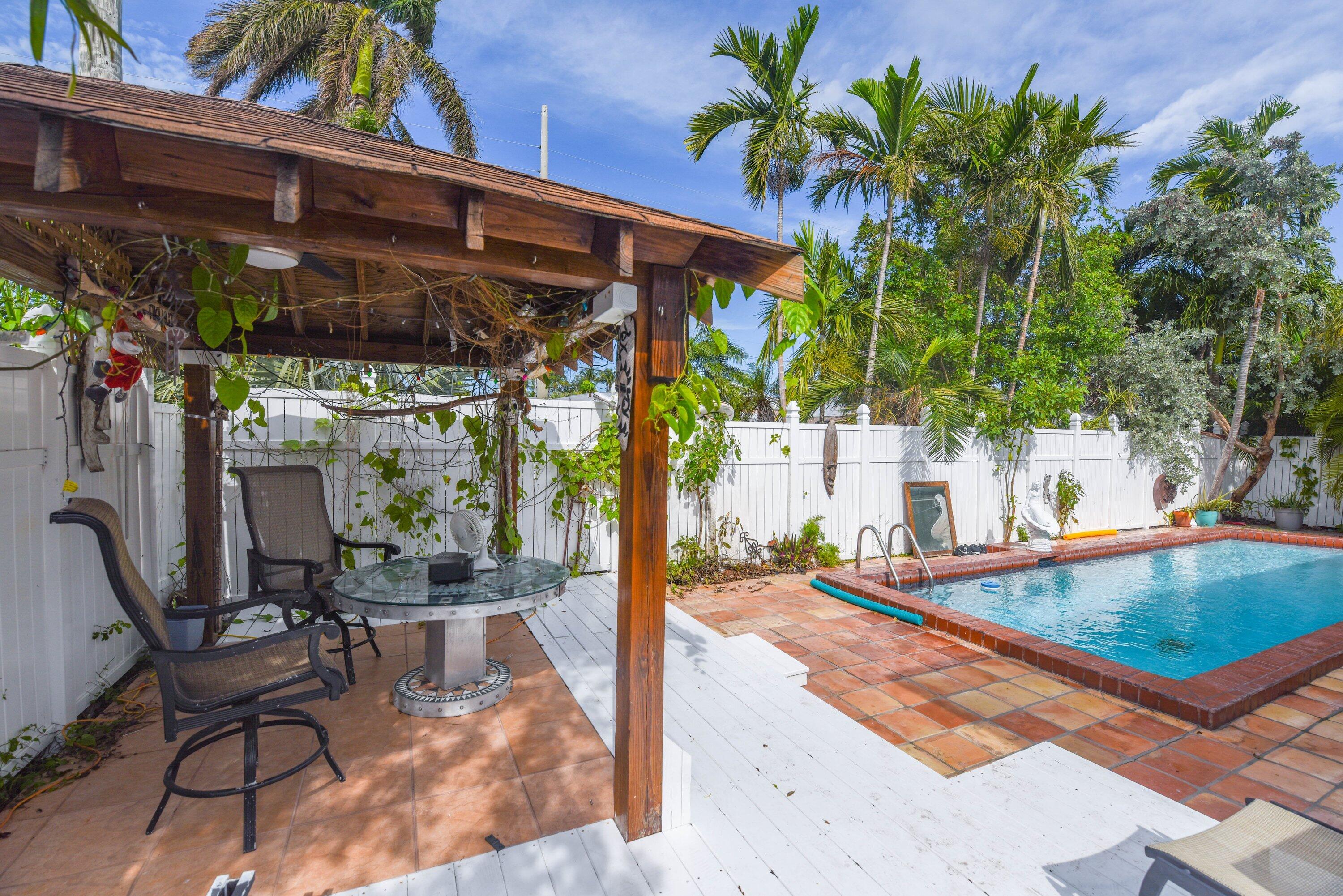 3421 Riviera Drive Key West, FL 33040 - Photo 23 of 32 a view of a chairs and table in the patio