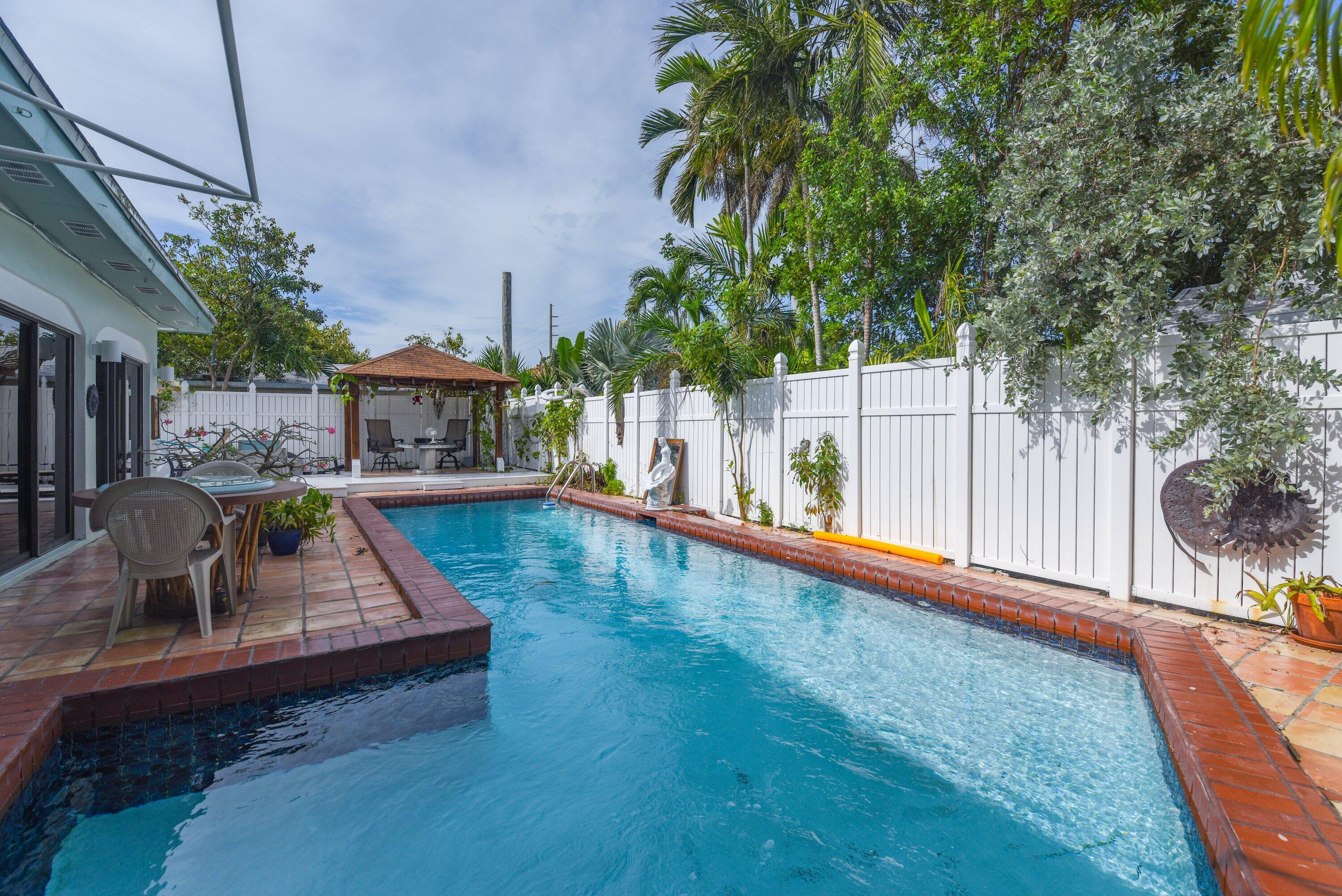 3421 Riviera Drive Key West, FL 33040 - Photo 31 of 32 a view of a swimming pool with a patio